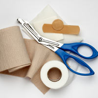 Surgical dressings, plasters, tape and scissors