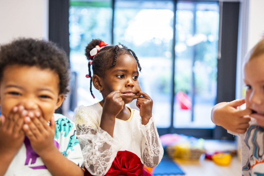 Children pulling faces and laughing